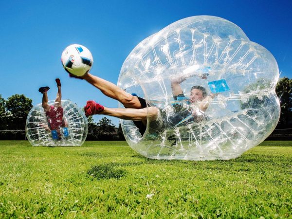 Bubble Soccer - Kugelz, close up ein mann tritt den Fußball